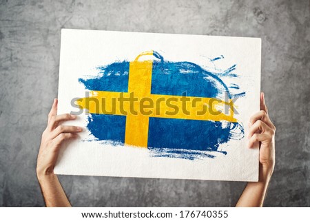 Sweden flag. Man holding banner with Swedish Flag. Supporting national team, patriotism concept.