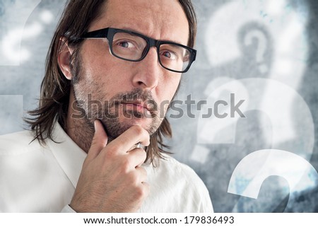 Businessman thinking and questioning. Portrait of thoughtful business person.