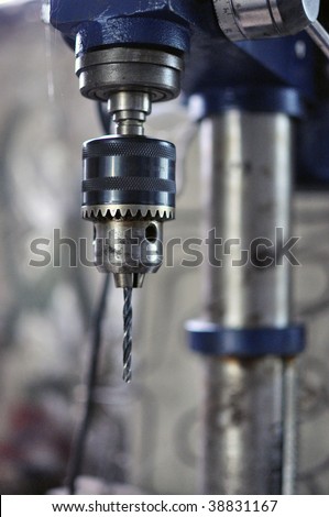 Close up image of head of a electric drill machine in ow light conditions.
