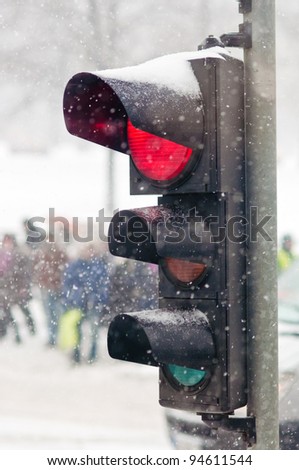 Red semaphore light. Traffic light in snow.