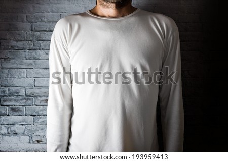Slim tall man posing in blank white t-shirt as copy space for your text or design.