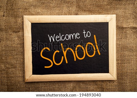 Welcome to school note on black message board