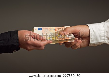 Money Loan. Bank officer loaning stack of euro banknotes money.