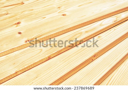 Pine planks stacked and ready for some carpentry job or wood works. Close up with selective focus and shallow depth of field.