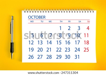 October Paper Calendar Page with Spiral Binding as Time Management and Schedule Concept, top view