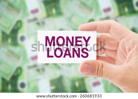 Man Holding Business Card with Money Loan Title, Euro Banknotes Pile in The Background. Loan Shark Concept.