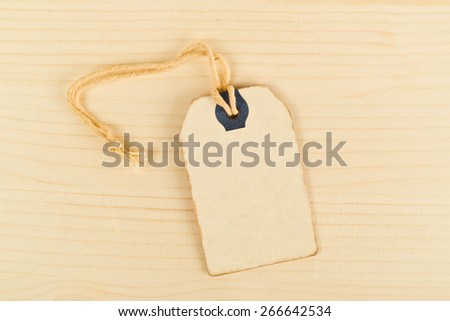 Top View of Vintage Price Tag Label on Wooden Texture Background as Copy Space, Filter Toned Image.