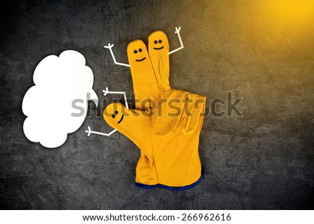 Three Happy Laughing Smileys on Fingers of Yellow Leather Protective Construction Industry Working Gloves with Speech Balloon as Copy Space
