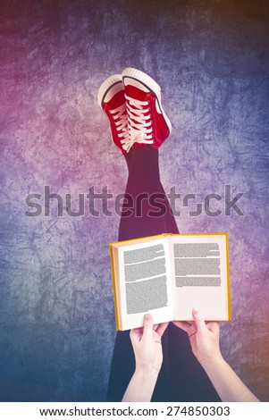 Young Woman Reading Pulp Fiction Book with Her Feet Raised in The Air, Generic Text on Pages
