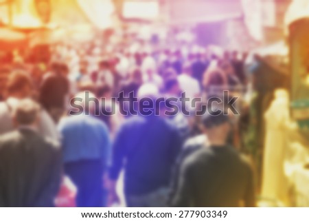 Blurred Crowd of People On Street, unrecognizable crowded population as blur urban background, Vintage Toned Image.