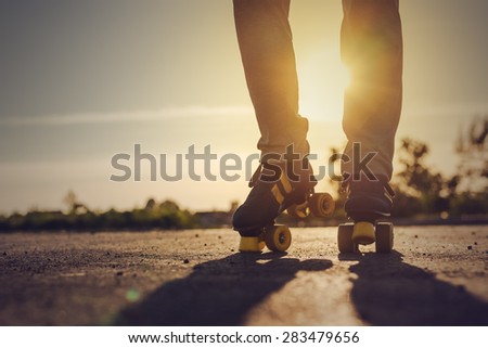 Woman Riding Roller Skates in Urban Environment in Sunset, Selective Focus Toned Image.