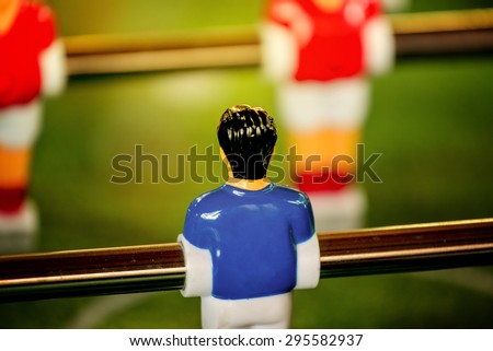 Vintage Foosball, Blue and Red Team Players in Table Soccer or Football Kicker Game, Selective Focus, Retro Tone Effect, Jersey Back as Copy Space