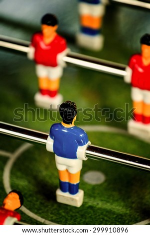 Vintage Foosball, Blue and Red Team Players in Table Soccer or Football Kicker Game, Selective Focus, Retro Tone Effect, Jersey Back as Copy Space