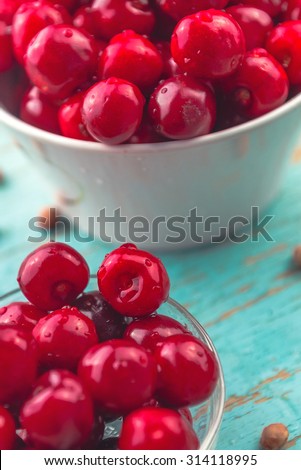 Sweet Cherry in Bowl on Rustic Table, Ripe Fresh Wild Cherries Fruit, selective focus with shallow depth of field