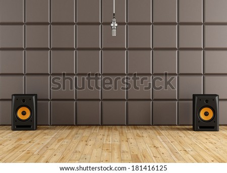 Professional microphone in a recording studio with brown acoustic panel.speaker and wooden floor - rendering