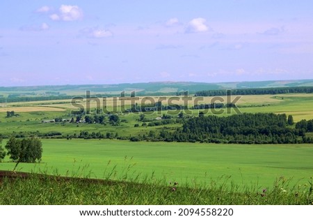 Similar – Image, Stock Photo A few wooden huts and many bushes and trees are standing around on a hilly green meadow landscape in the nature park Ammergau Alps in Upper Bavaria and a piece of bicycle path can be seen as well.