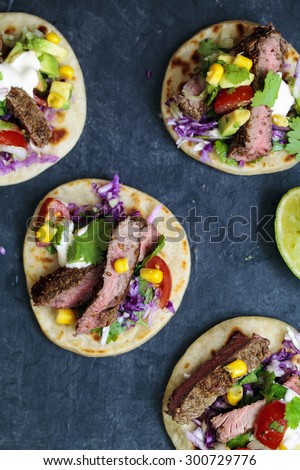 Beef steak tortillas with corn, avocado and tomato salsa and red cabbage coleslaw
