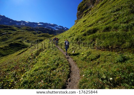 Young people on hike in Swiss mountains