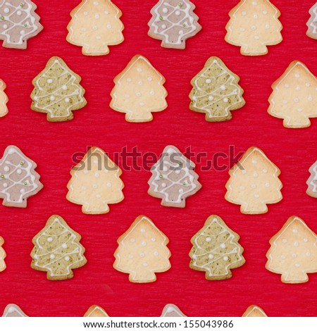 christmas tree shaped cookies on a red background, seamless pattern