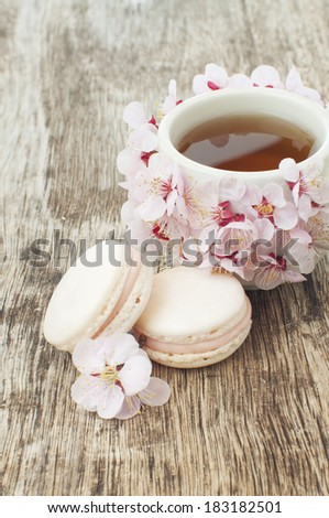 pink macaroons and a cup of tea with flowers