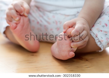 One year old old baby hands and feet closeup