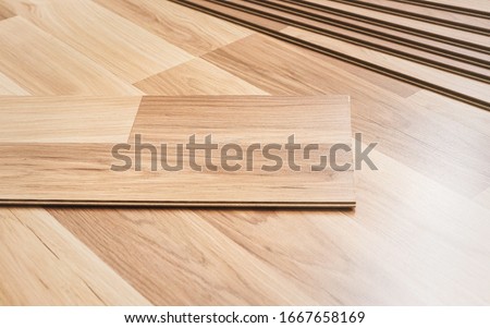 Installing laminated floor, detail on wooden tiles ready to be fit Stockfoto © 