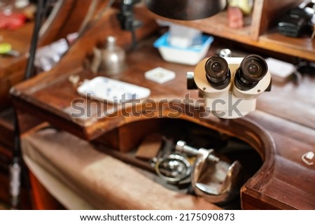 Inspection microscope at jeweller's desk, closeup detail to eyepiece lenses, blurred background Сток-фото © 