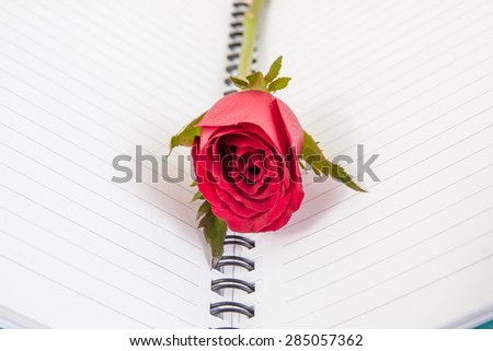 Red rose flower and Notepad book