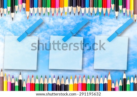 Paper color and wood clip note on blue sky background.
