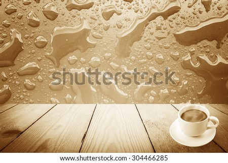 Vintage style - Abstract rain drops on a window or water drops on grass and coffee cup and wood background