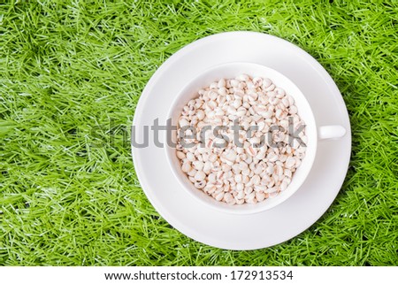 Job's tear in white ware on grass