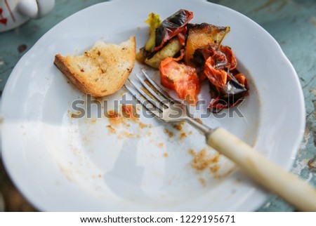 Food leftovers on the plate. Vegetables, meat and bread. ストックフォト © 