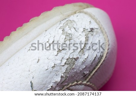 Close up Torn white leather sneakers. Leather shoes. Shoe repair concept. Photo stock © 