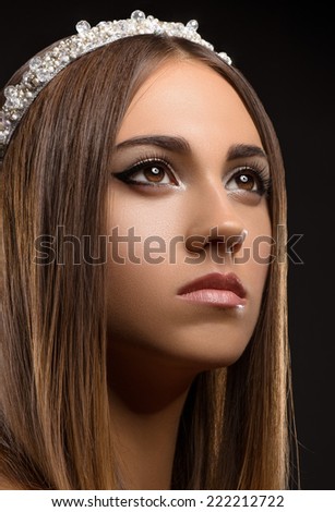Beautiful girl with a crown on his head, a portrait of a beautiful girl, studio, evening makeup, princess, queen, glamorous young girl, dreamy girl, black background