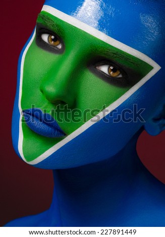 beautiful creative makeup, blue-green makeup art, a beautiful girl on a red background