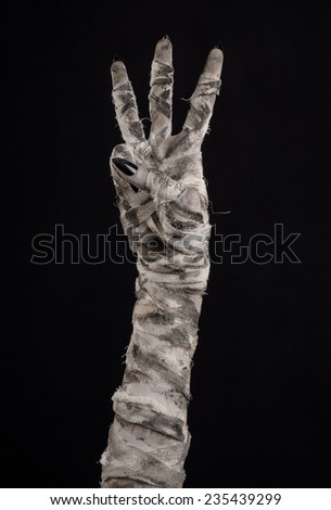 Halloween theme: terrible old mummy hands on a black background
