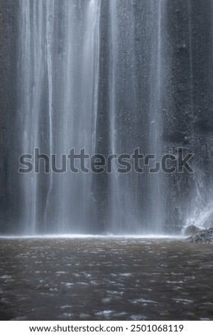 Similar – Foto Bild Männlicher Reisender auf Wasserfall in verschneiten bergigen Wald im Winter Tag