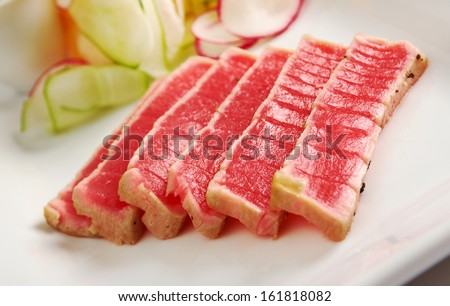 Tuna Sashimi - Sliced Raw Tuna on Daikon (White Radish) with Seaweed and Cucumber