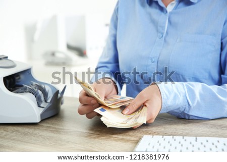 Female teller counting money at cash department, closeup Stock foto © 
