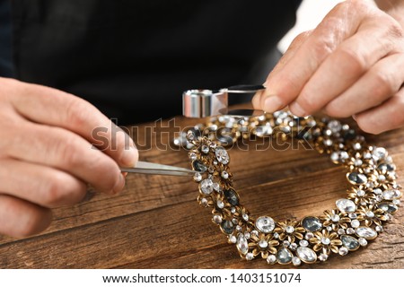 Similar – Image, Stock Photo Mature jeweler creating gold item using a pencil in workshop