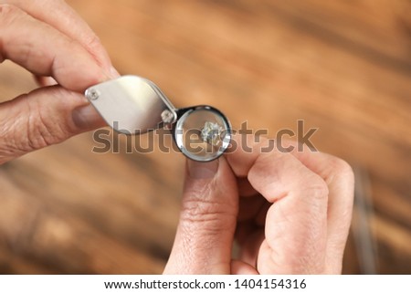 Similar – Image, Stock Photo Mature jeweler creating gold item using a pencil in workshop