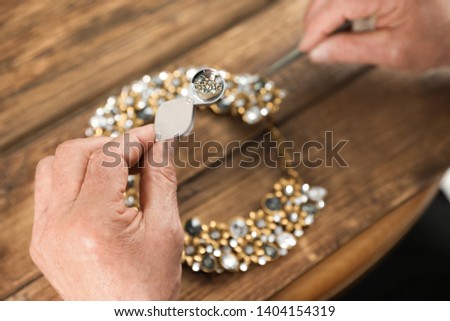 Similar – Image, Stock Photo Mature jeweler creating gold item using a pencil in workshop