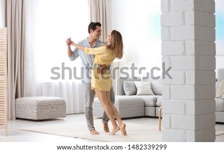 Similar – Image, Stock Photo Young happy couple staying at home with their baby son sitting on the living room floor.