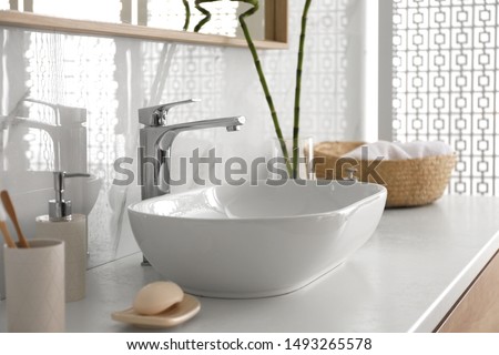 Stylish vessel sink under mirror in bathroom. Interior element