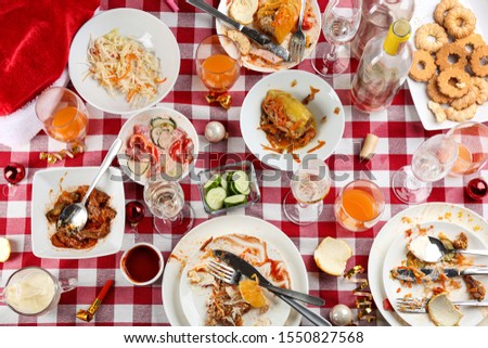 Flat lay composition of food leftovers after party on table with checkered cloth ストックフォト © 
