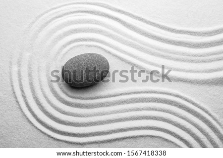 Grey stone on sand with pattern, top view. Zen, meditation, harmony Stok fotoğraf © 