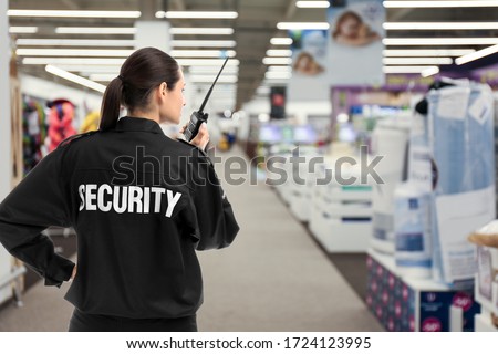 Security guard using portable radio transmitter in shopping mall, space for text Foto stock © 
