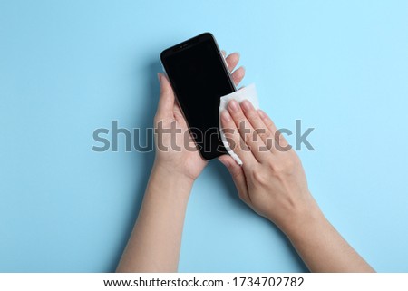 Similar – Image, Stock Photo Hand cleaning a phone screen with wet antibacterial wipes to avoid virus contamination.
