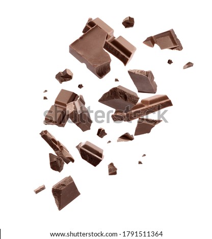 Milk chocolate pieces falling on white background