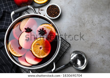 Delicious mulled wine and ingredients on grey table, flat lay. Space for text Сток-фото © 